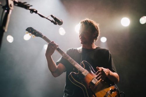 Looking at fretboard while playing guitar